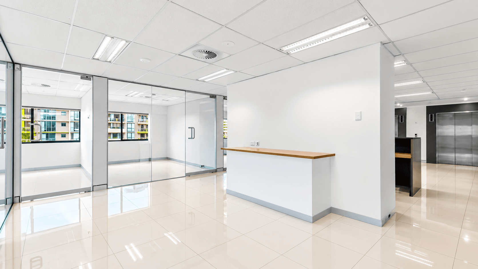 Level 8 reception and waiting area with glass partitioned offices